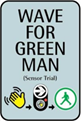 Image of "Wave for Green Man" signage