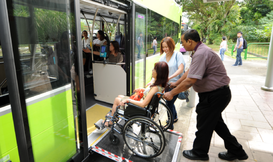 A passenger boarding the bus with a stroller