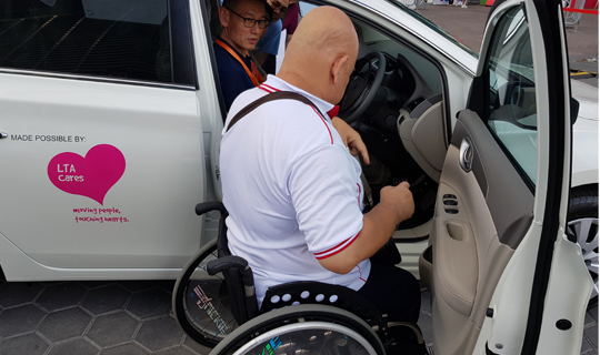 This is an image of a beneficiary trying out the new instructional vehicle.