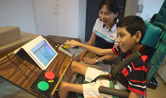 This is an image of a beneficiary using the assistive equipment and technical aids