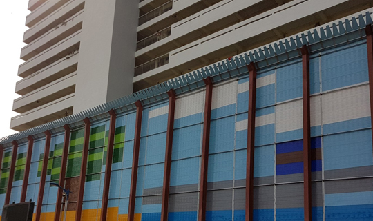 A noise barrier barricades a surrounding HDB flat