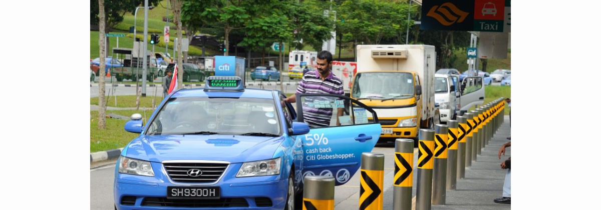A passenger boarding onto a taxi at a designated taxi stand