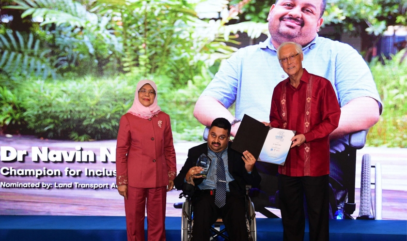 Photo of Dr Navin receiving the GCTEA (UBS Promise) Award  with President Halimah Yacob (left) and Emeritus Senior Minister Goh Chok Tong (right)