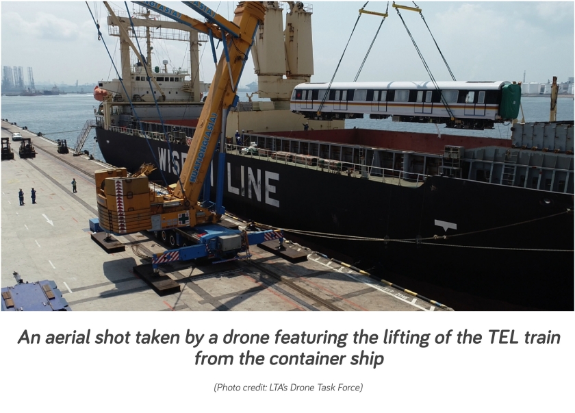 Aerial photo taken by a drone of the TEL train being lifted from container ship