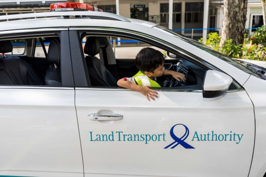 Image of young FOLT participant sitting in the LTA vehicle enforcement car vehicle