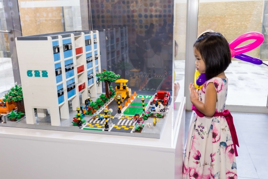 Image of child taking a look at LTA's lego set