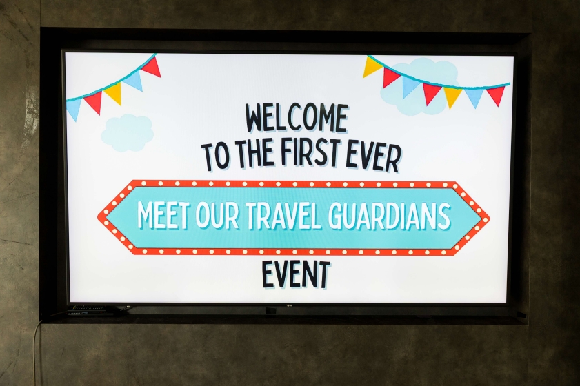 Image of screen that says "Welcome to the first ever Meet Our Travel Guardians Event"