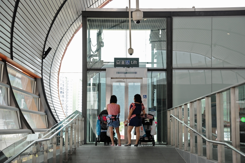 Image of mothers with strollers outside lift at MRT